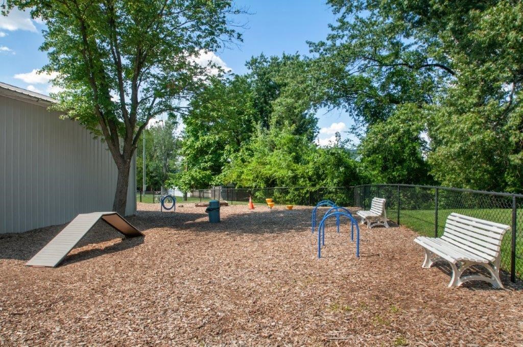 a park with a playground and benches and trees
