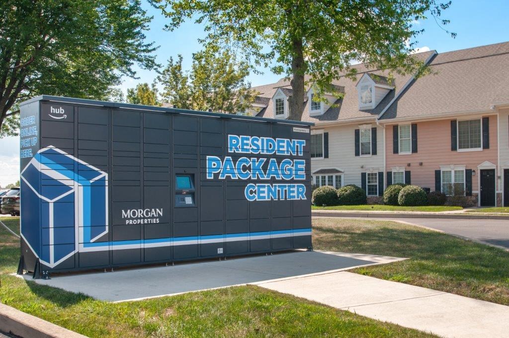 a modular building with a resident package center sign in front of a house