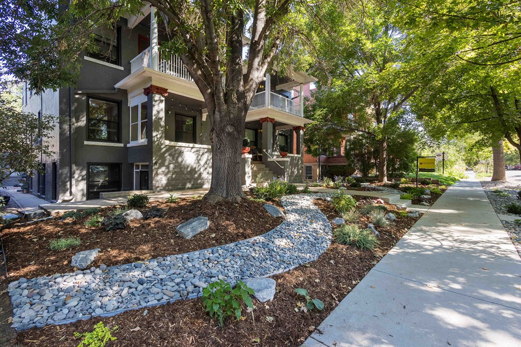 front view of the building with sidewalk and trees