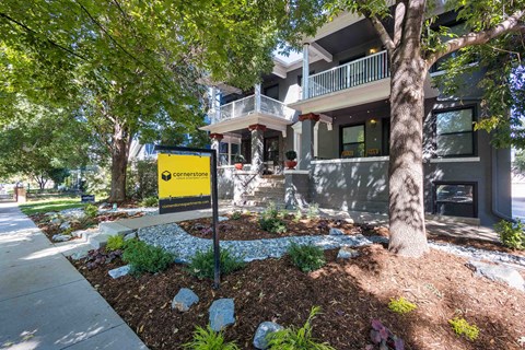 the front of a house with a yellow sign in front of it