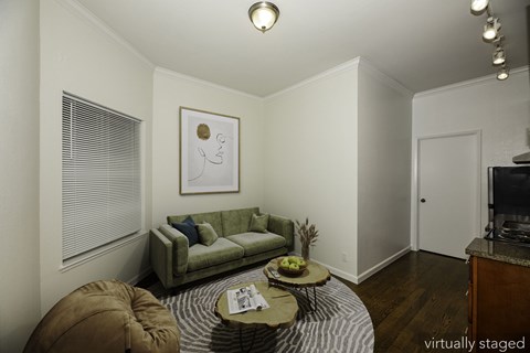 A living room with a green couch and a coffee table.