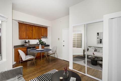 A modern kitchen with a dining table and chairs.