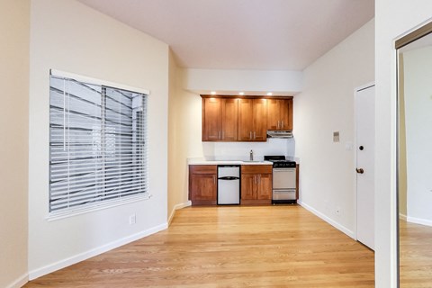 A kitchen with wooden cabinets and a white fridge.