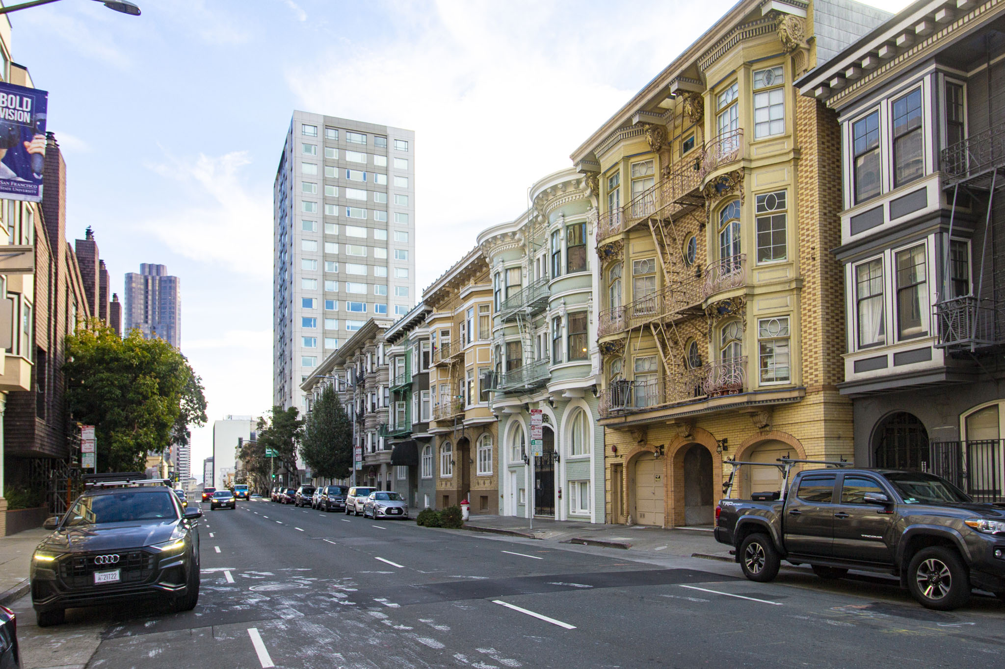 A street scene with cars and buildings.