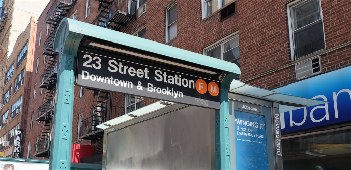 a sign for 23 street station 60 on the side of a building