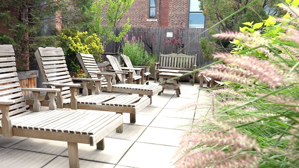 a group of wooden benches in a garden