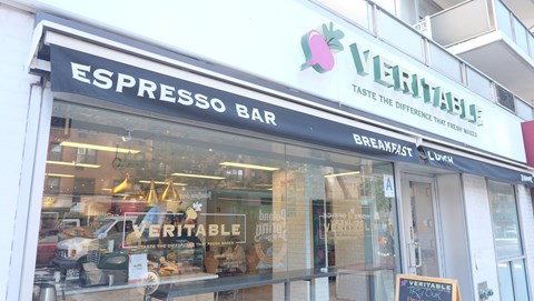the front of a store called espressos bar with a sign in the window