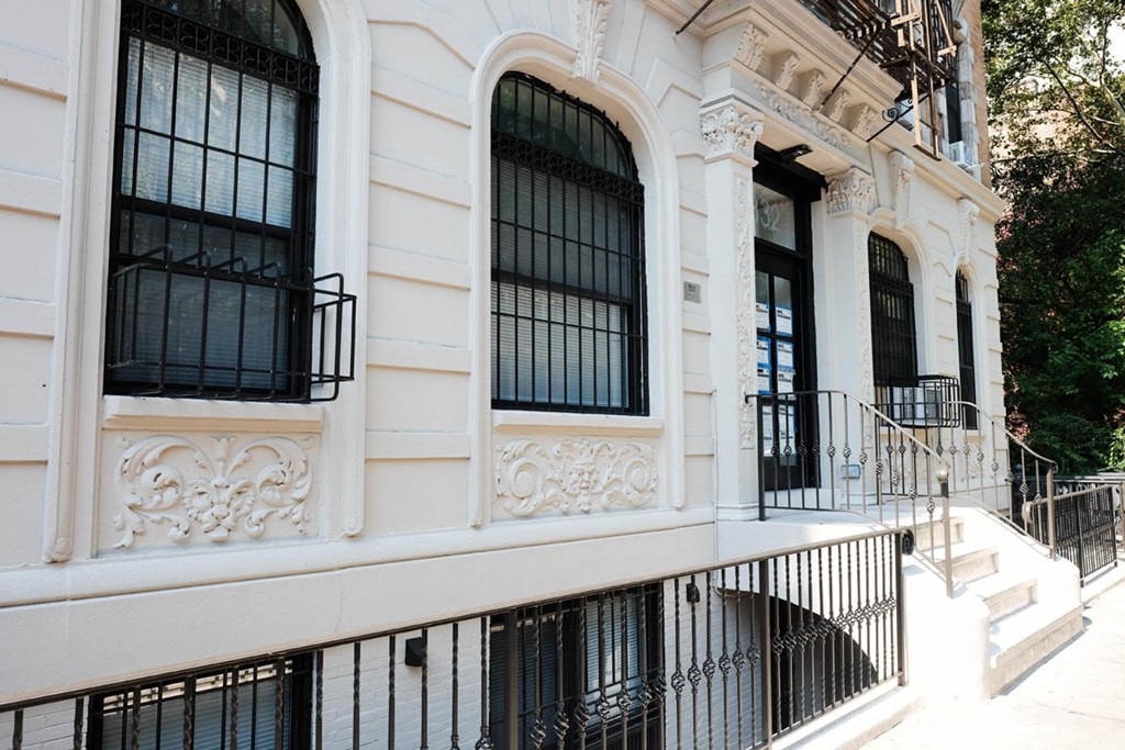 the facade of a building with barred windows and stairs
