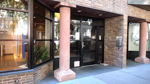 the front entrance of a building with glass doors