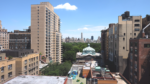 the view of the city from the roof of a building