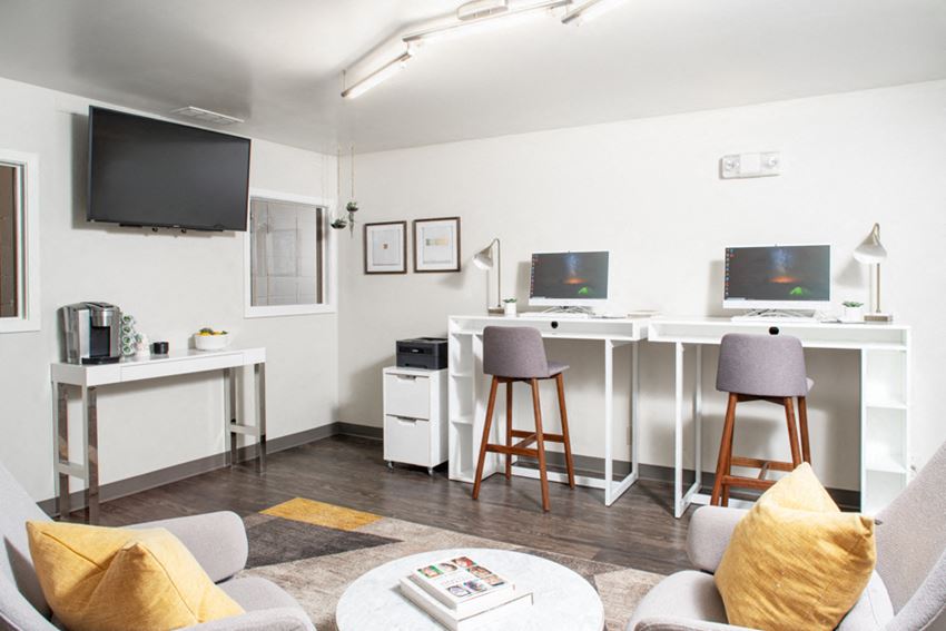 a living room with a couch and a table with two stools
