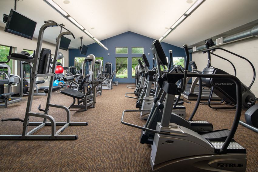 a room filled with cardio equipment and exercise equipment