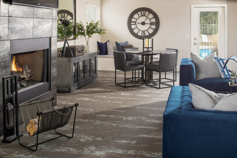 a living room with couches and chairs and a fireplace   and a clock