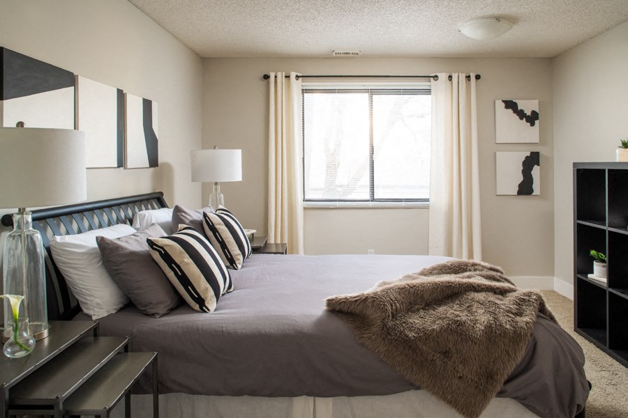 a bedroom with a large bed and a window