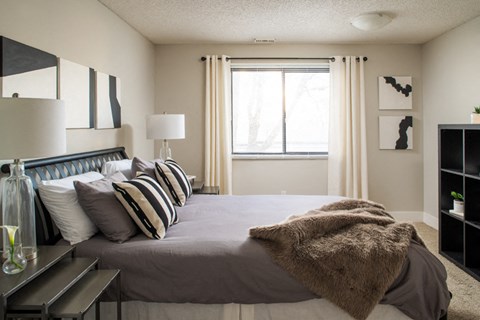 a bedroom with a large bed and a window