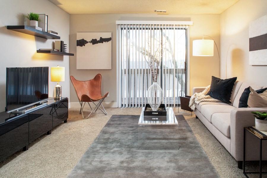a living room with a white couch and a television