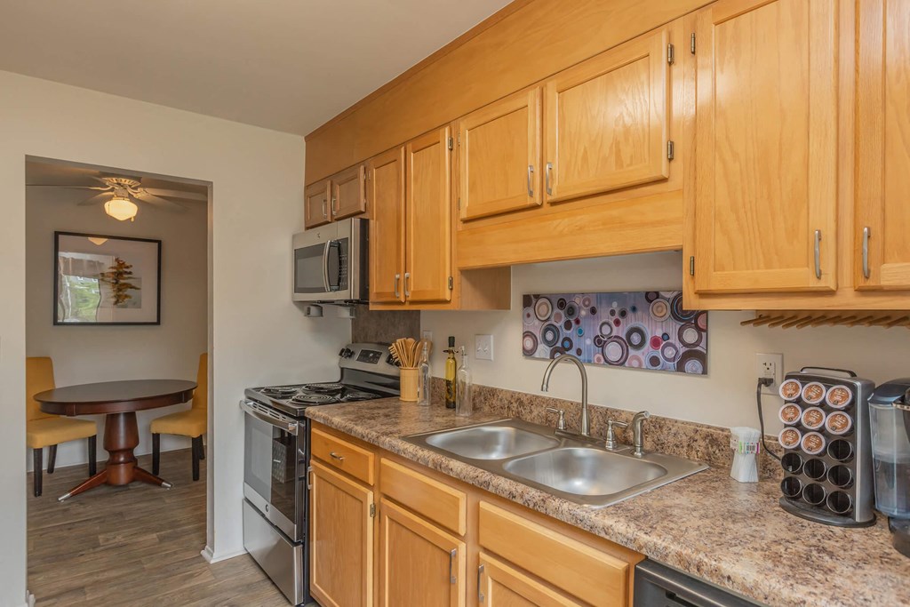 a kitchen with wooden cabinets and granite counter tops