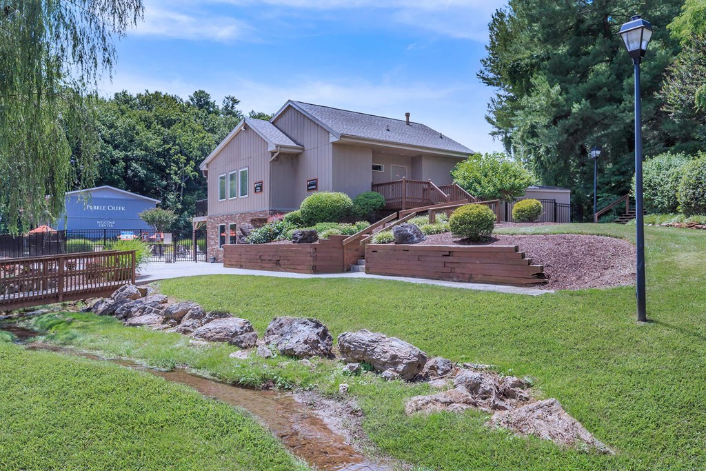 a house with a yard and a pathway in front of it