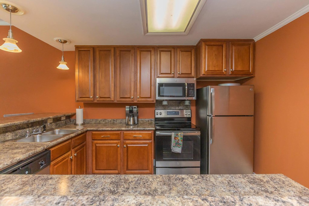 a kitchen with granite counter tops and stainless steel appliances