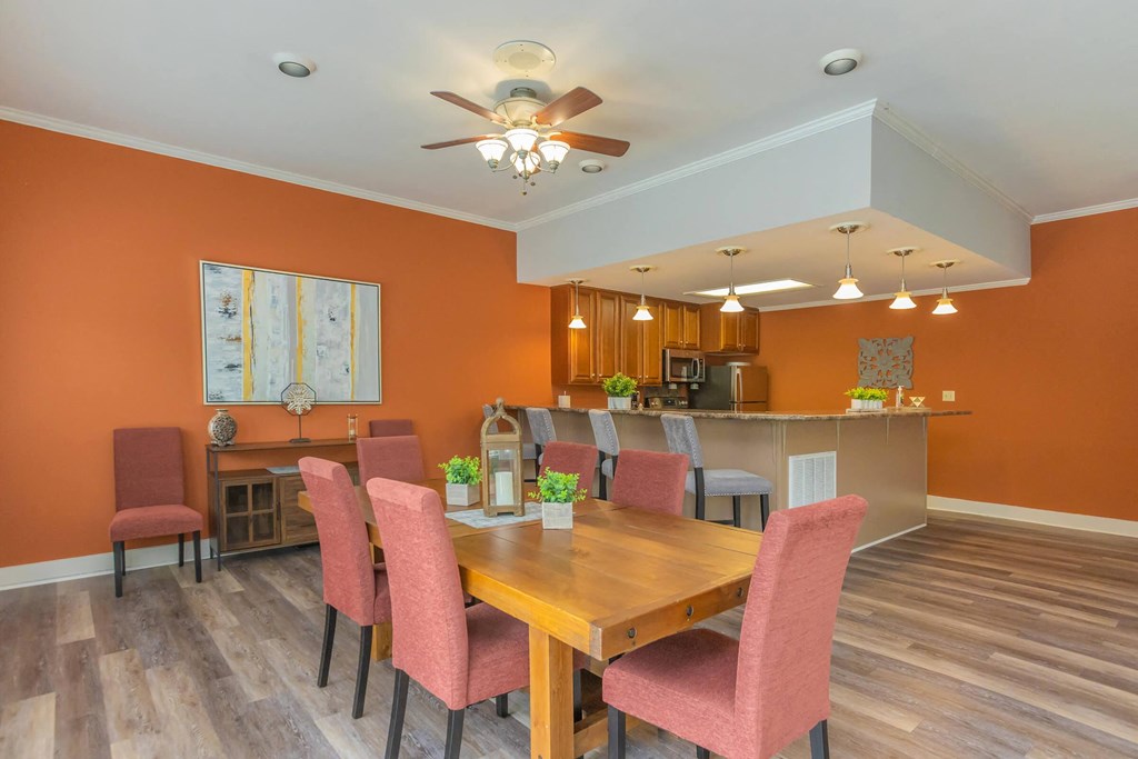 a dining room with a wooden table and chairs
