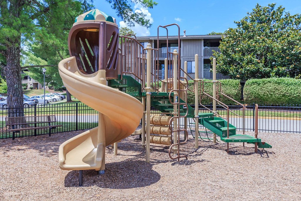 a playground with a slide and other playground equipment