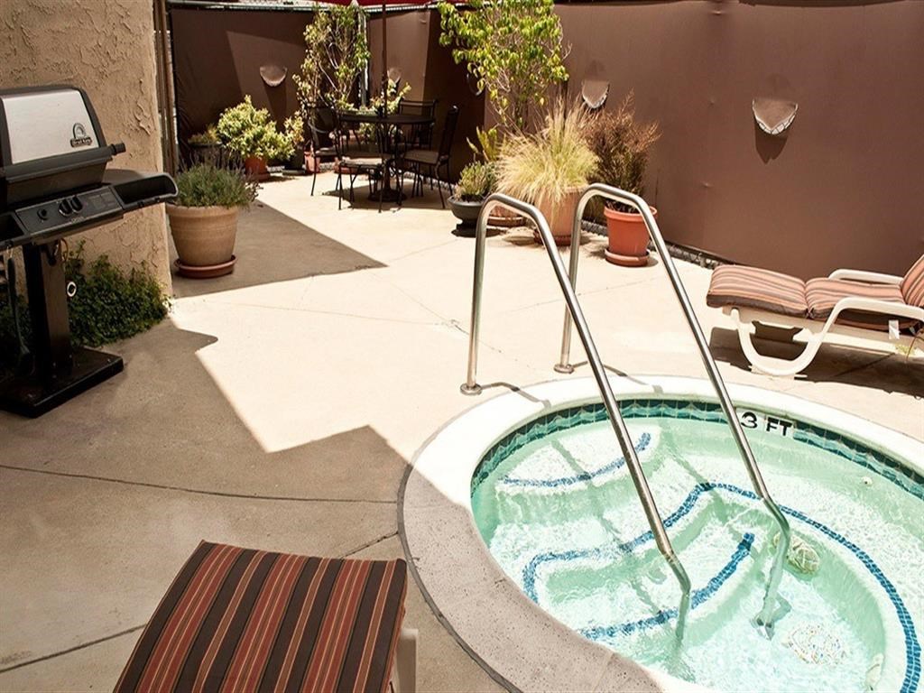 a hot tub and a grill in a backyard pool