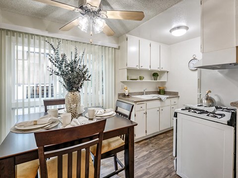 a kitchen and dining room with a table and chairs