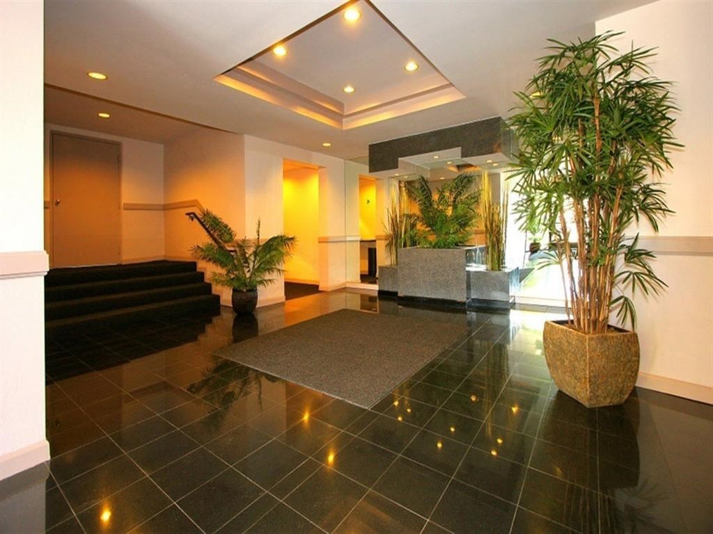 the lobby or reception area of a hotel with plants