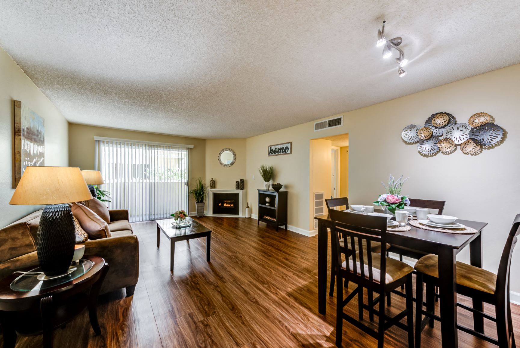 the view of a living room and dining room with a table and chairs