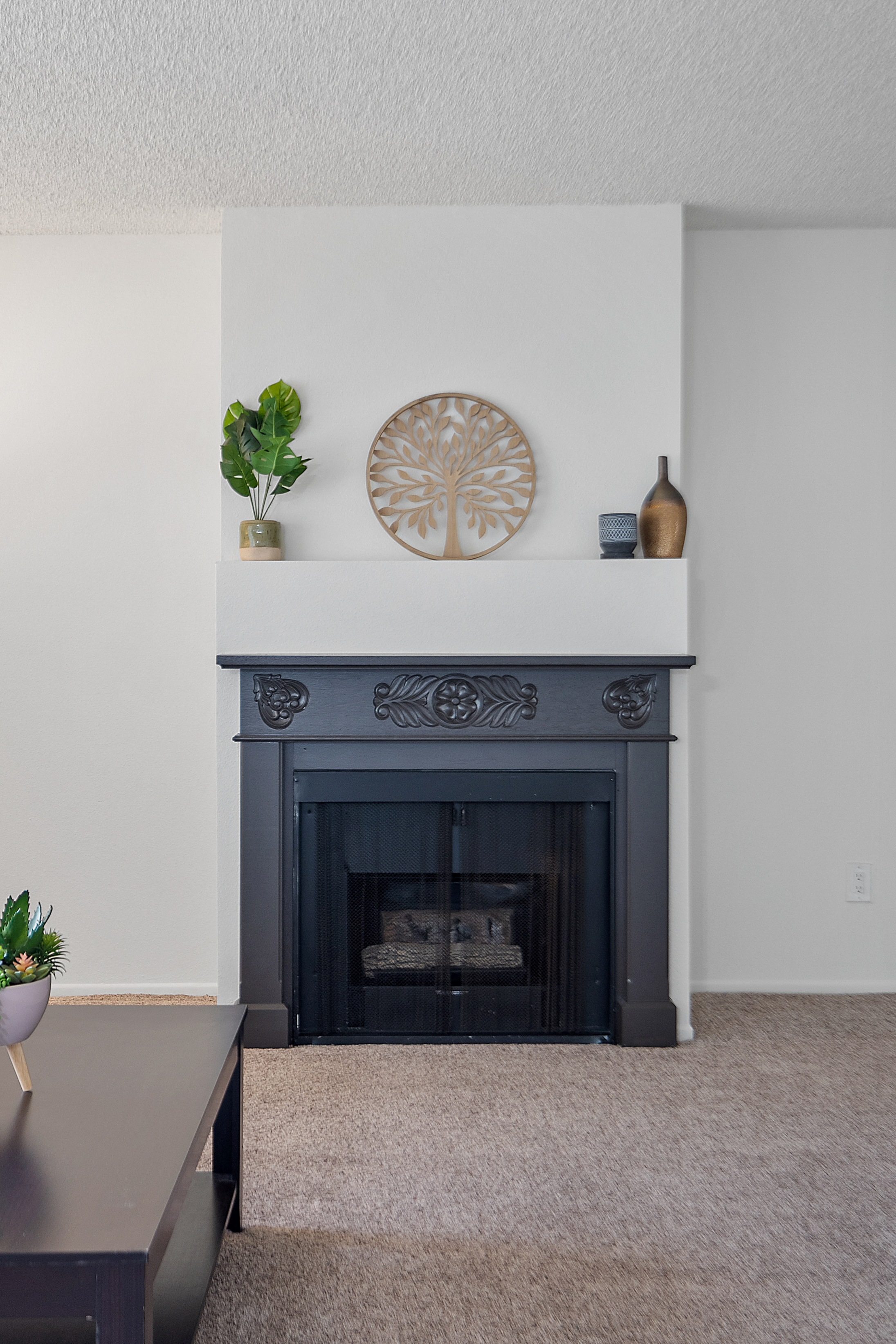 a living room with a fireplace and a table