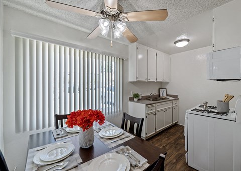 A kitchen with a table set for a meal.
