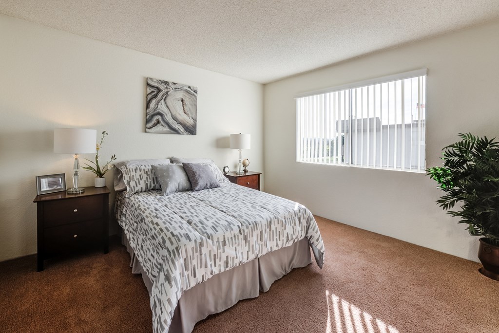the view of a bedroom with a bed and a window