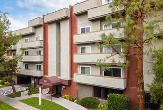 An areal image of the Hallmark Apartments in Sherman Oaks, CA, showcasing the front of the building and the curb