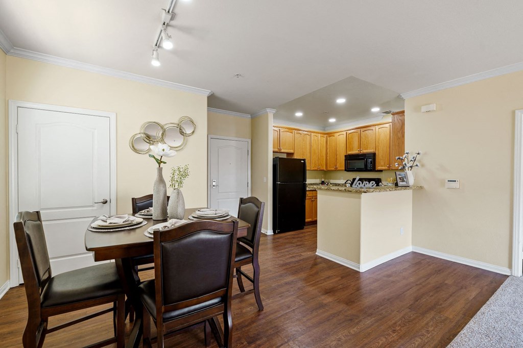 a dining room and kitchen with a table and chairs
