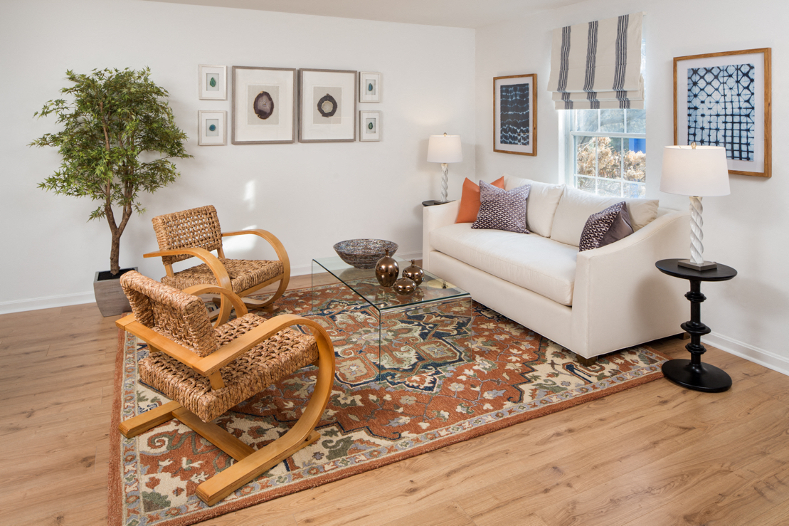Furnished living room with a sofa, coffee table, and high ceiling at Westridge Gardens