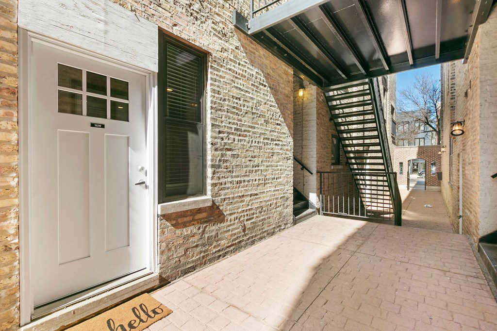 the entrance to a brick building with a white door