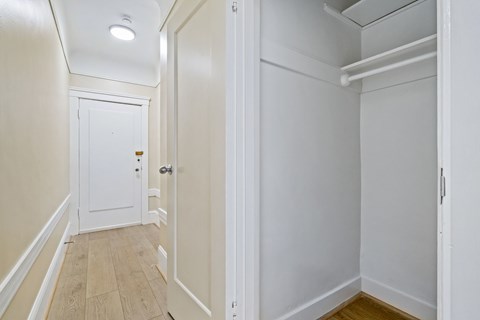 A white door is at the end of a hallway.