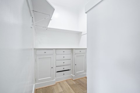 A white room with a cabinet and drawers.