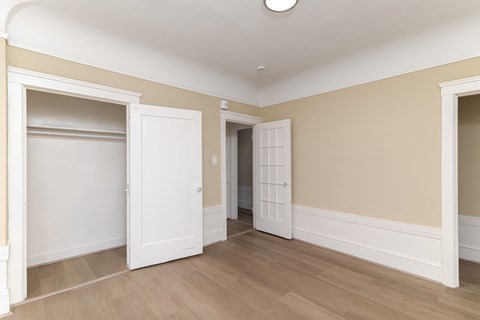 A room with a white door and a window.
