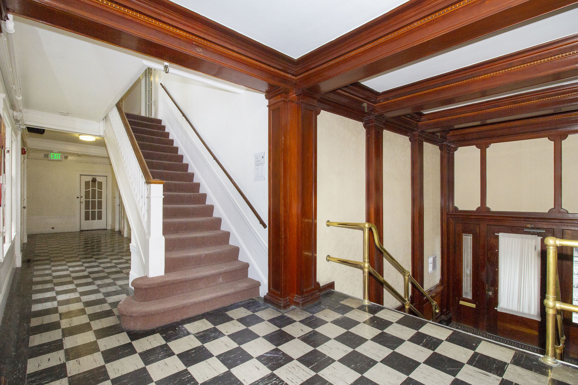 A staircase with a checkered floor.