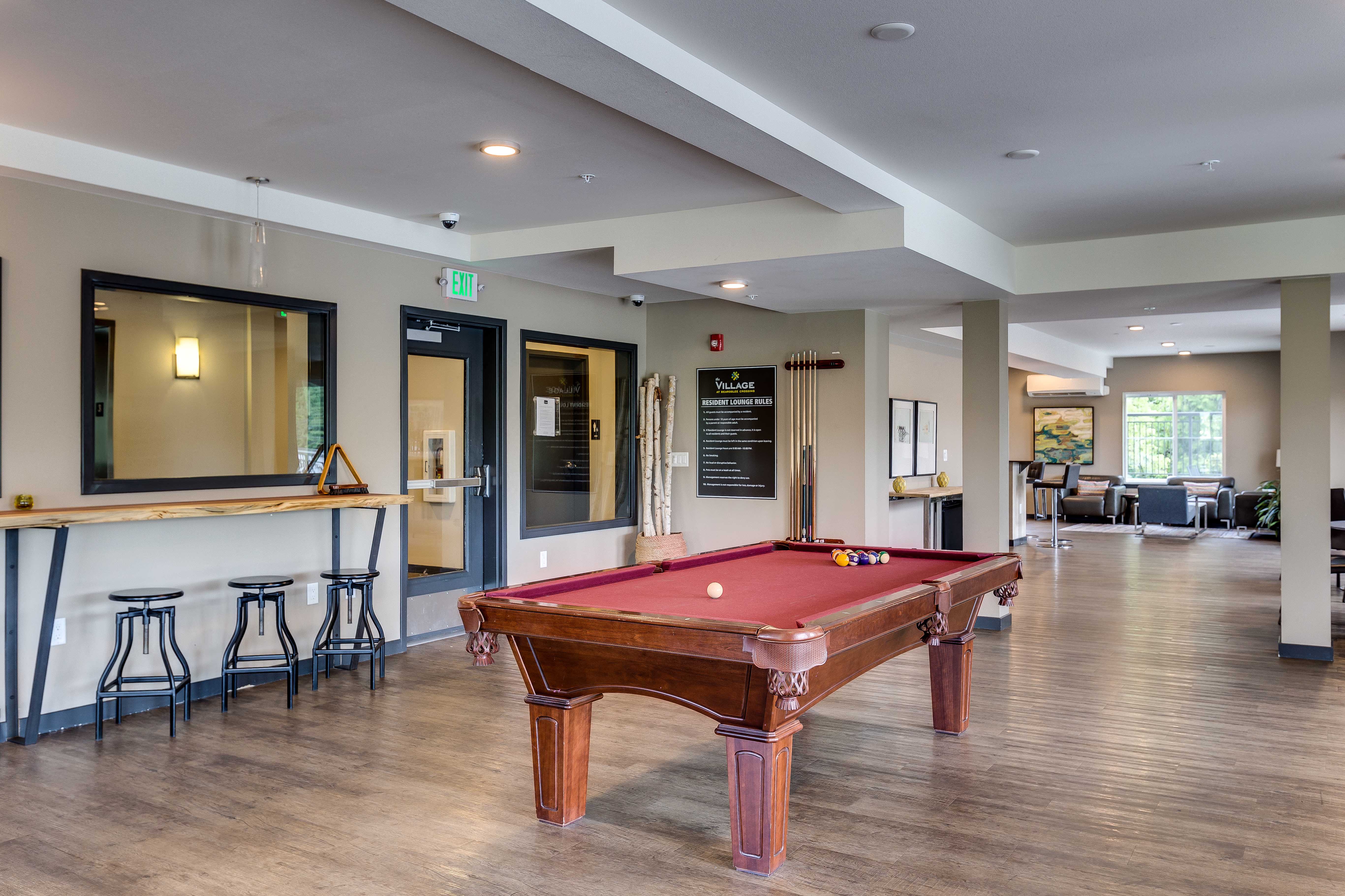a games room with a pool table and a bar