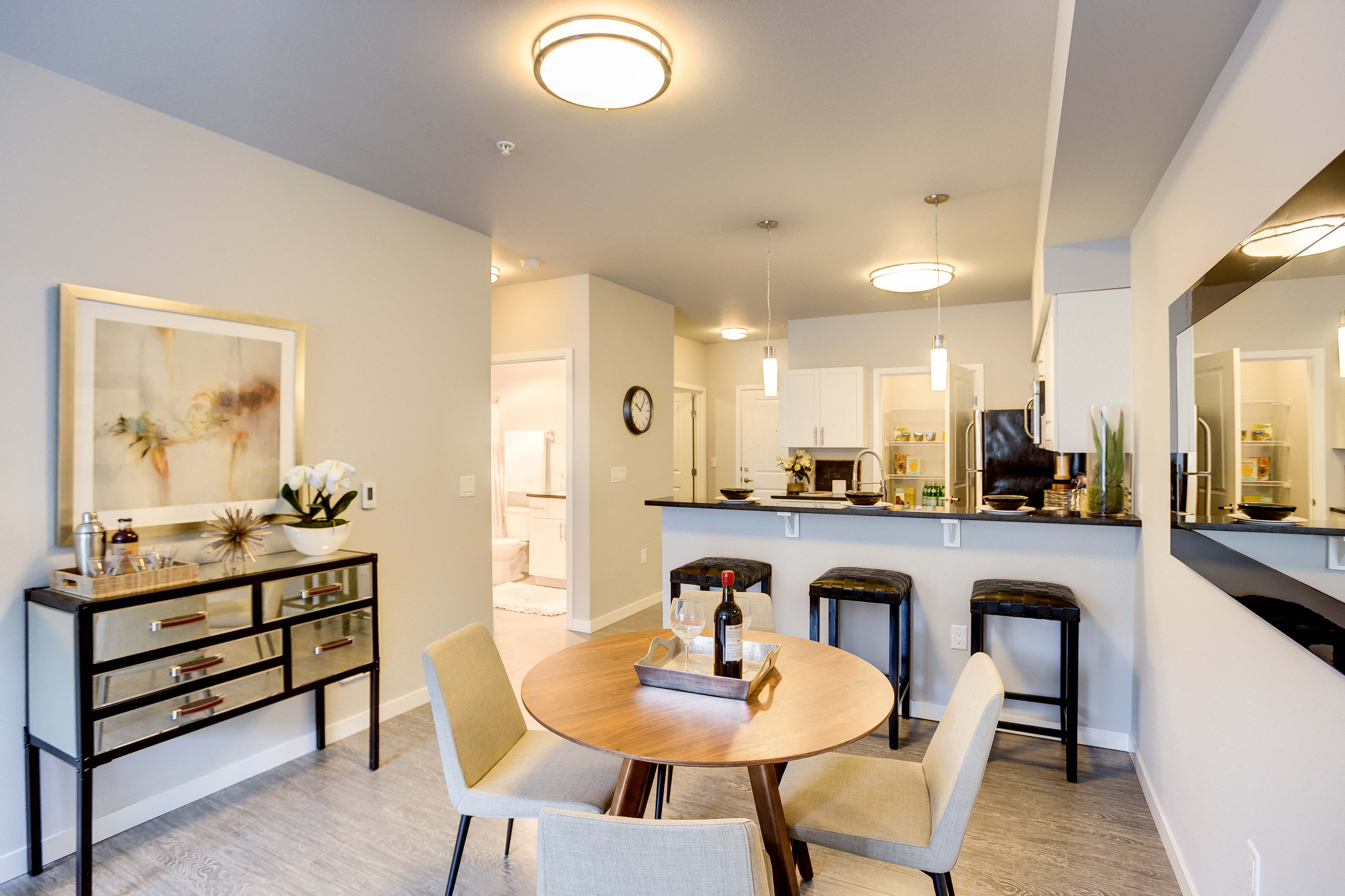 a dining room and kitchen with a table and chairs