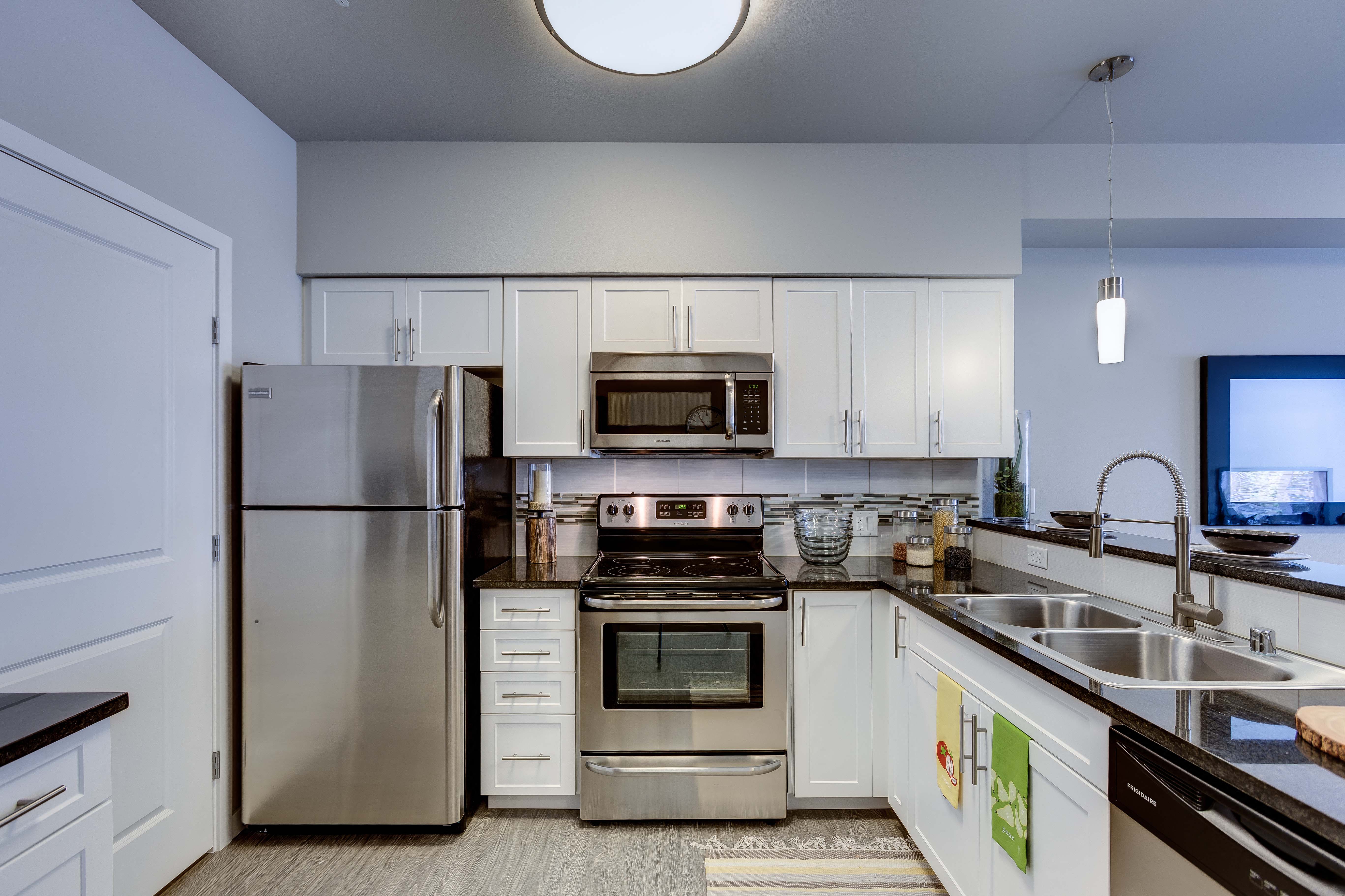 a kitchen with stainless steel appliances and white cabinets