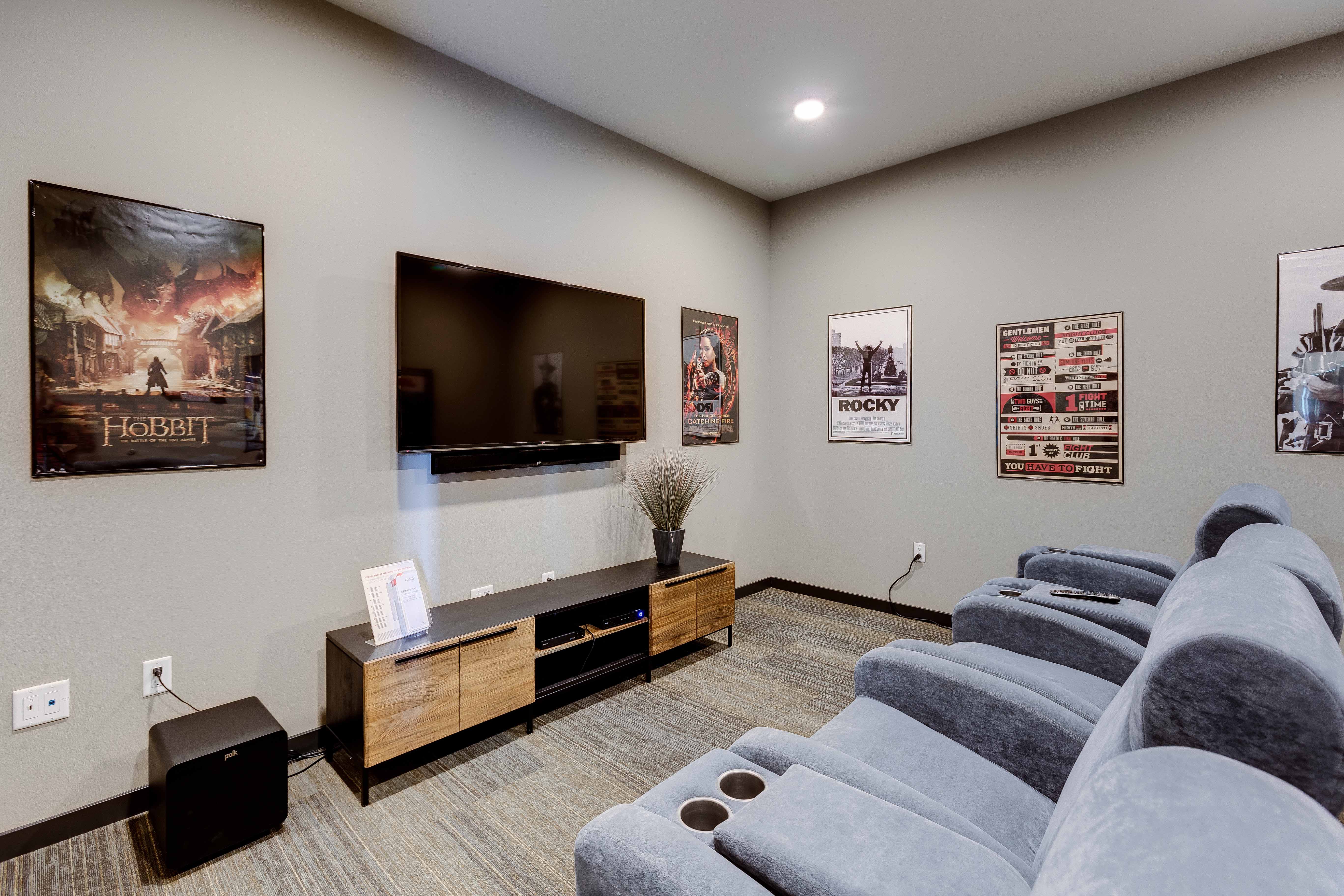 a living room with couches and a tv on the wall