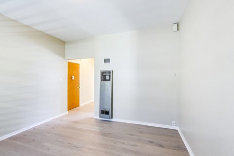 A room with a vending machine and a door.