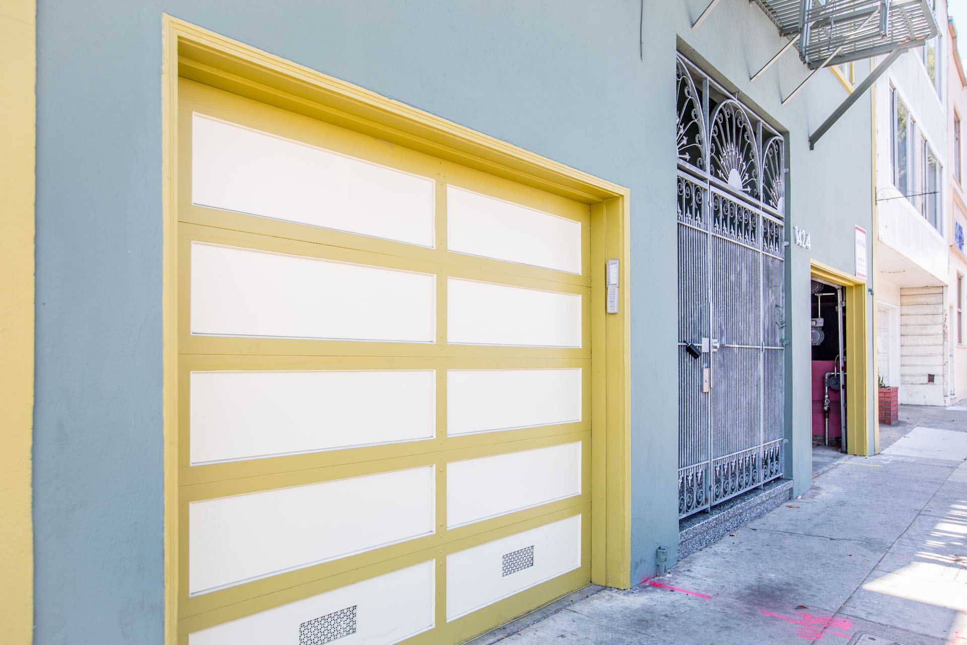 A yellow garage door is closed.