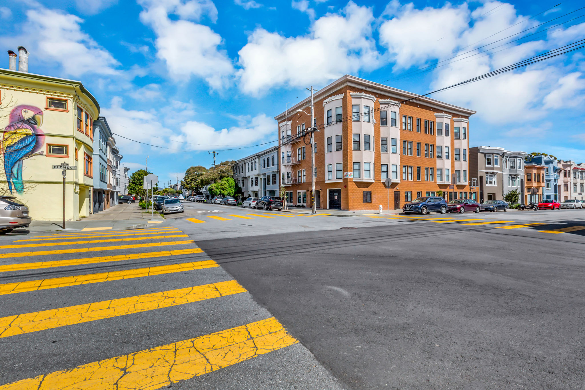 A street view with a crosswalk and buildings on either side.