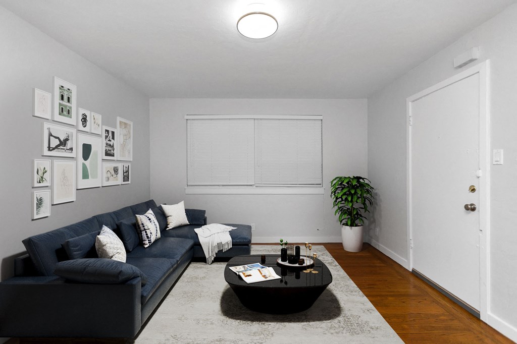 a living room with a blue couch and a black coffee table