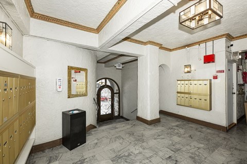 A room with a black speaker on the floor.