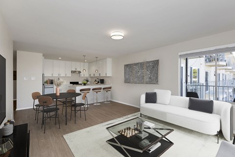 A modern living room with a white sofa and a coffee table.